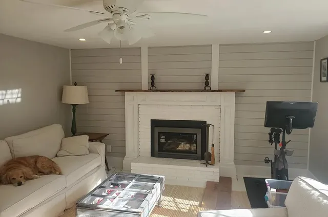a living room with furniture and a fireplace