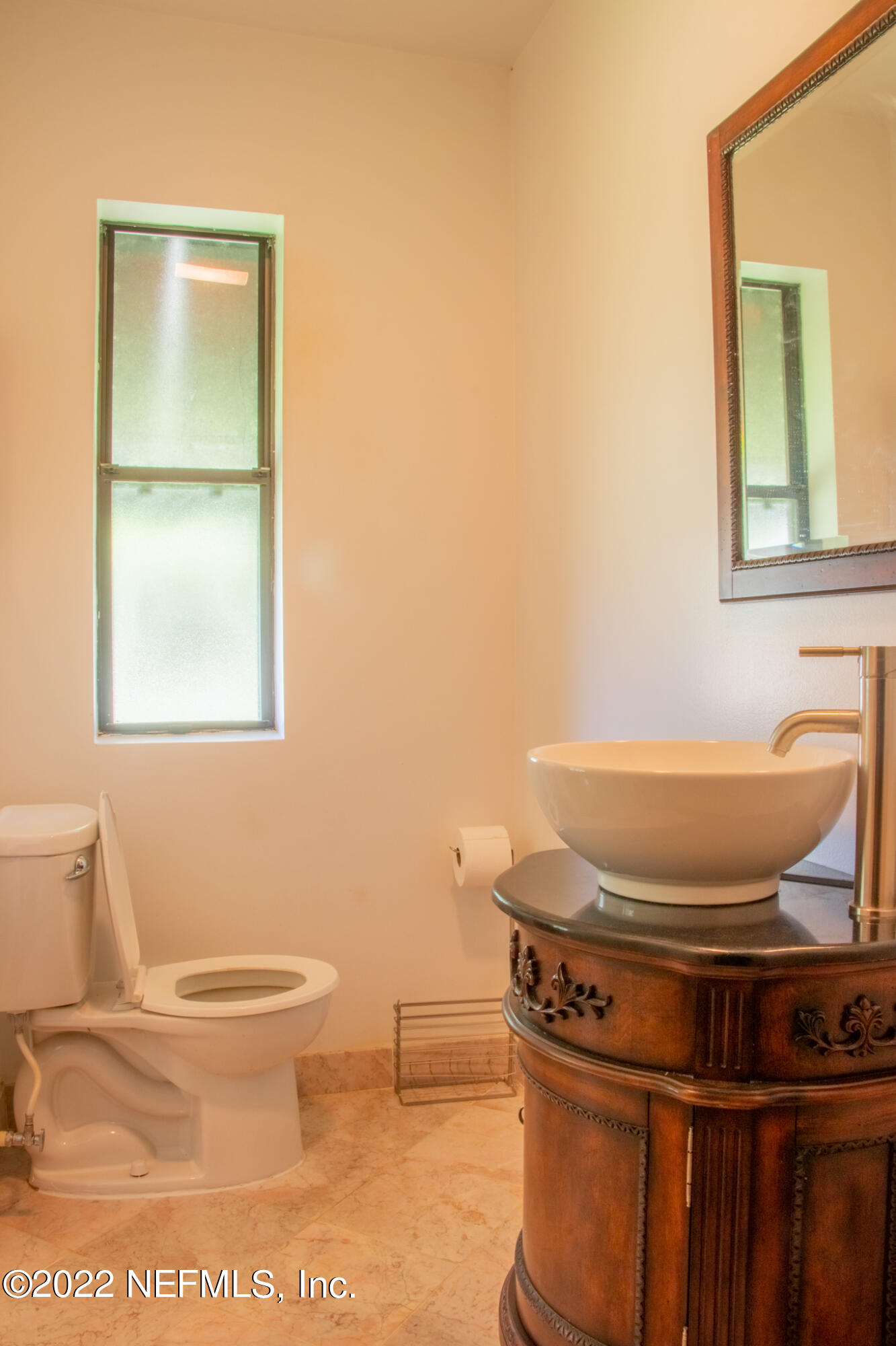 6415 Wesleyan Road Jacksonville, FL 32217 - Photo 13 of 36 a bathroom with a toilet and a sink