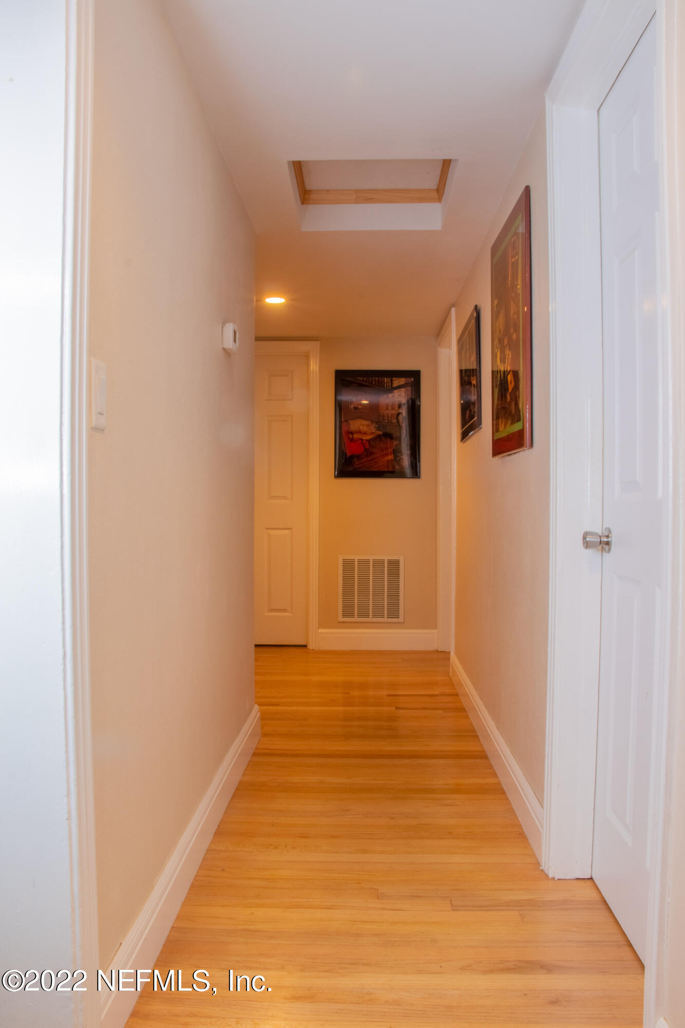 6415 Wesleyan Road Jacksonville, FL 32217 - Photo 14 of 36 a view of a hallway with wooden floor and a bathroom