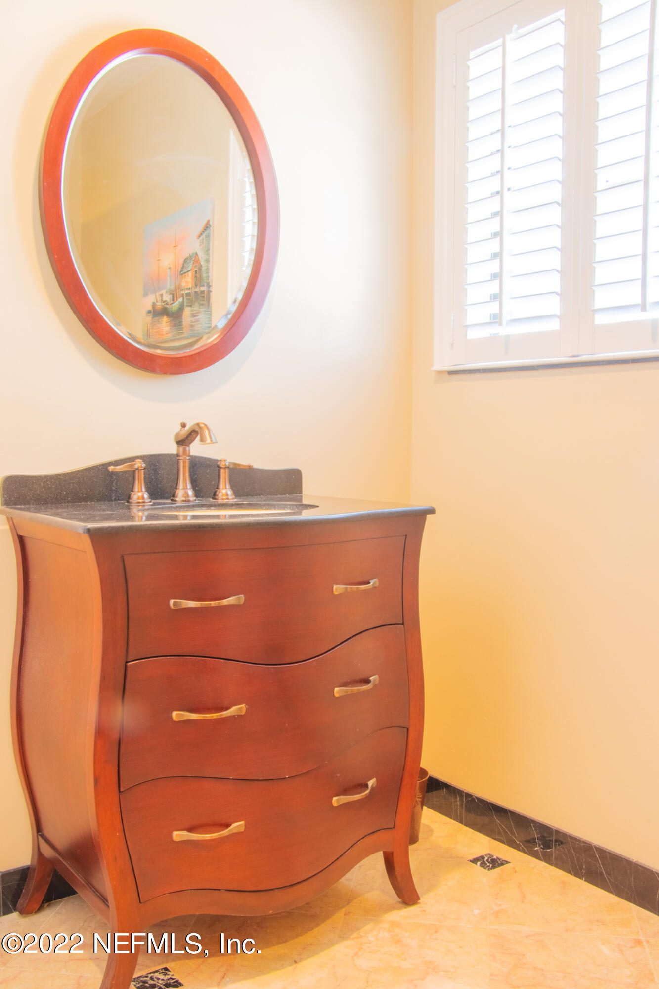 6415 Wesleyan Road Jacksonville, FL 32217 - Photo 18 of 36 a bathroom with a sink and a mirror