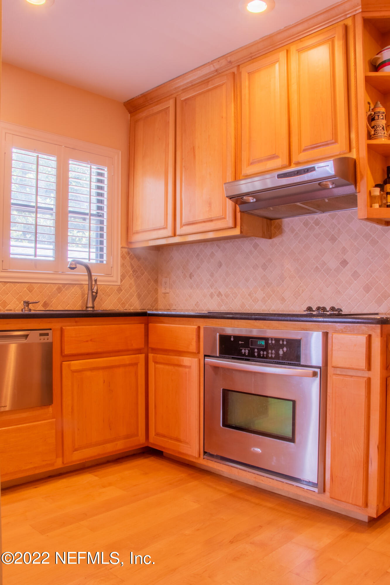 6415 Wesleyan Road Jacksonville, FL 32217 - Photo 19 of 36 a kitchen with stainless steel appliances granite countertop a stove a sink and a microwave
