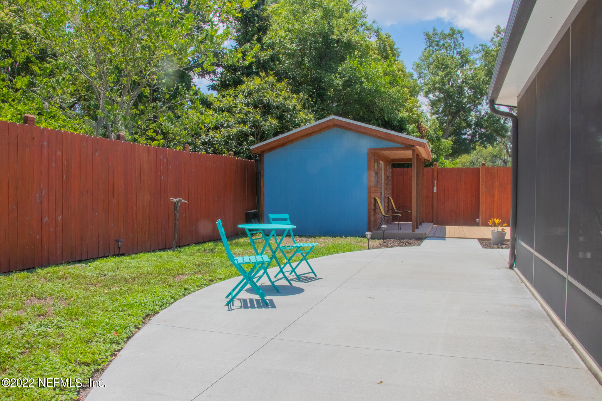 6415 Wesleyan Road Jacksonville, FL 32217 - Photo 25 of 36 a view of backyard with a table and chairs