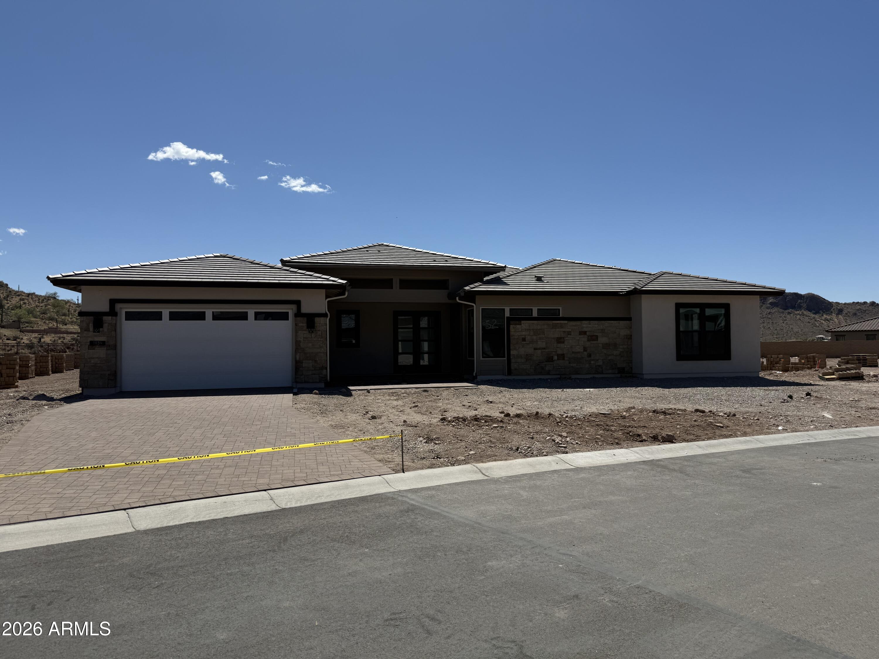a front view of a house with a yard and a garage