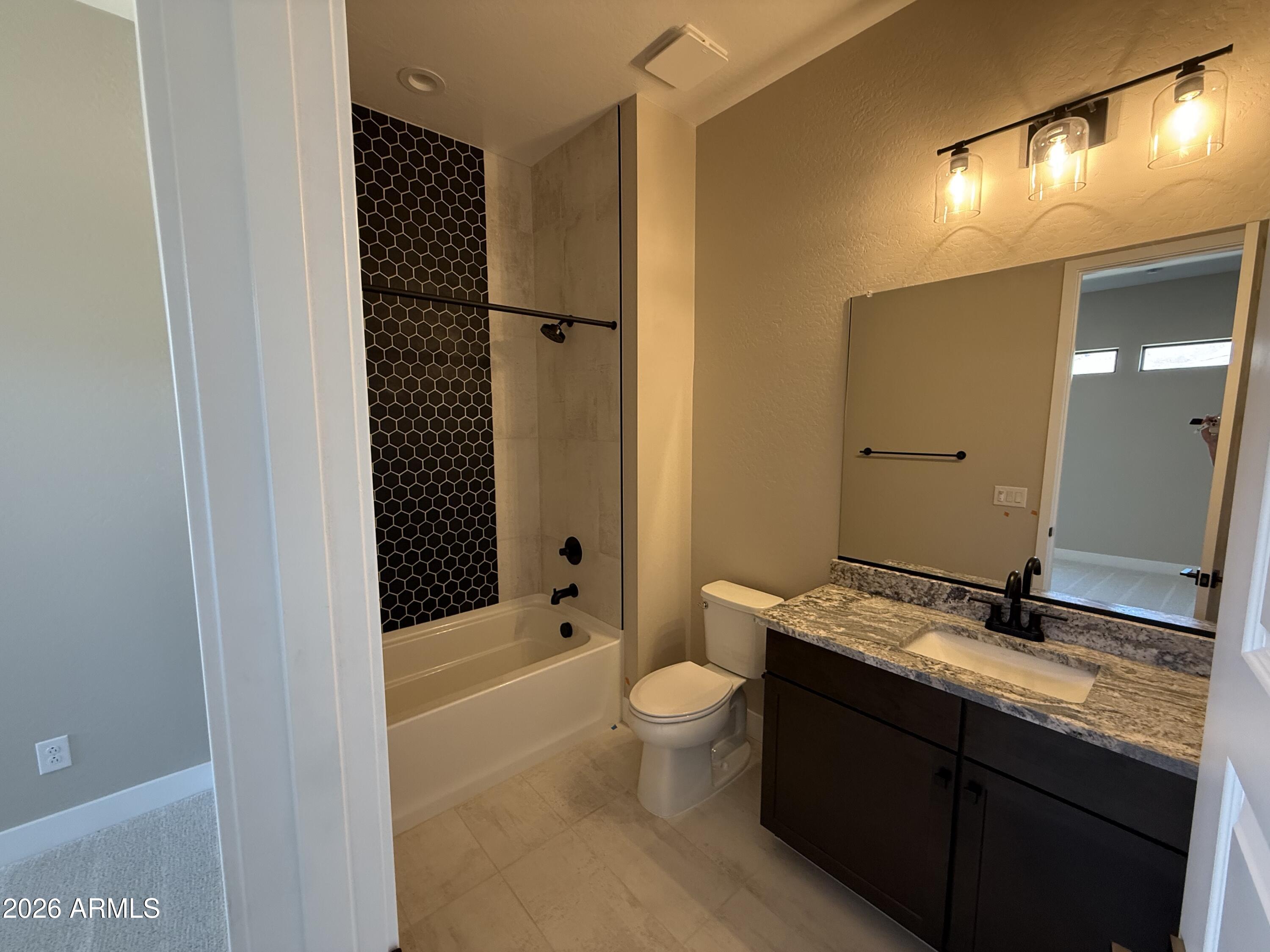 11139 East Rio Bravo Road Gold Canyon, AZ 85118 - Photo 10 of 14 a bathroom with a granite countertop sink toilet and shower