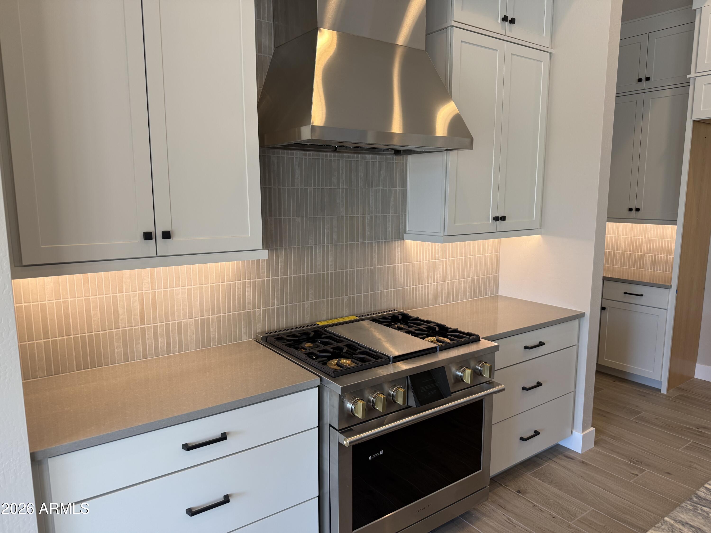 11139 East Rio Bravo Road Gold Canyon, AZ 85118 - Photo 2 of 14 a kitchen with granite countertop a stove and a sink