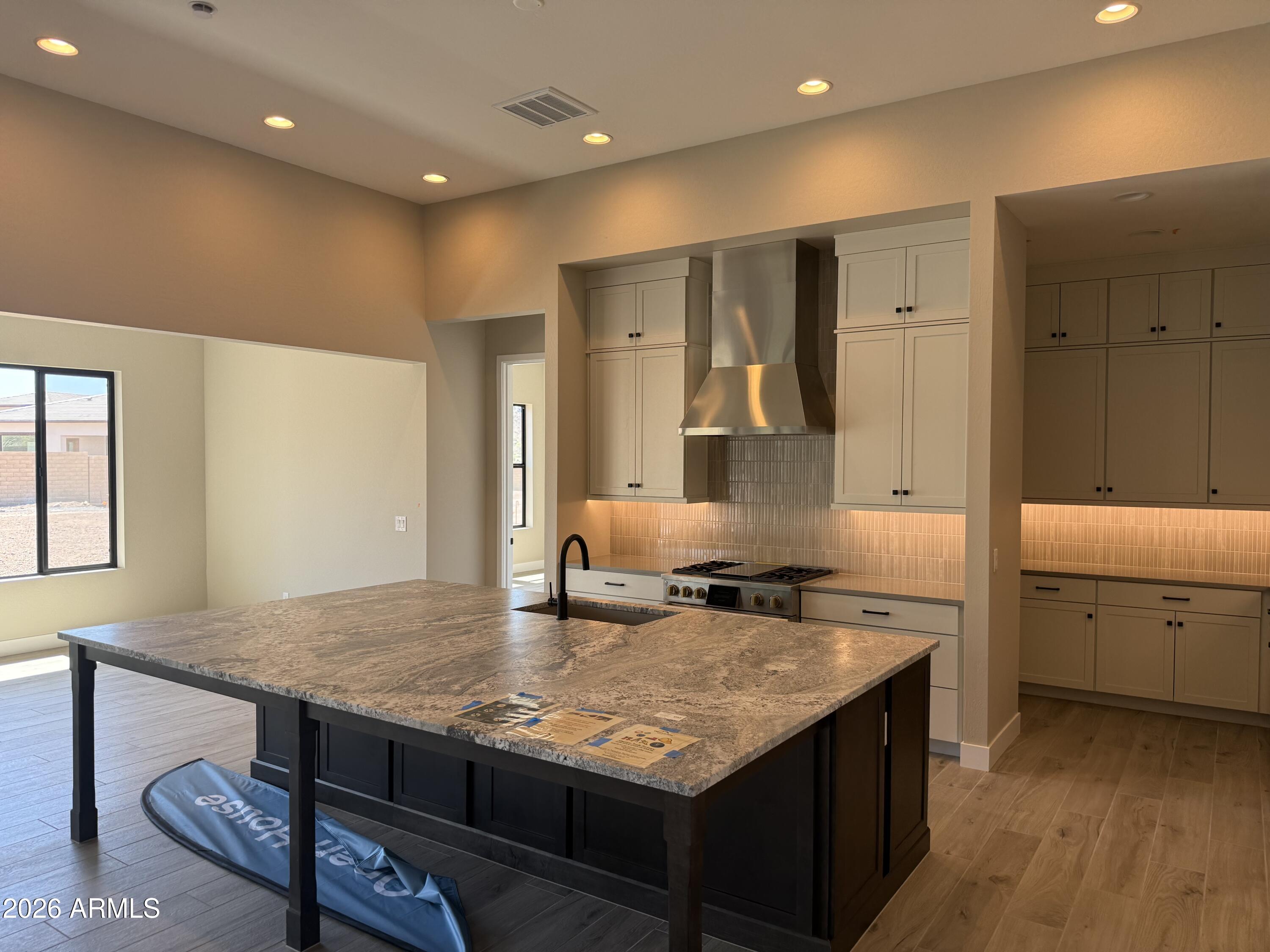 11139 East Rio Bravo Road Gold Canyon, AZ 85118 - Photo 3 of 14 a kitchen with center island table and chairs in it
