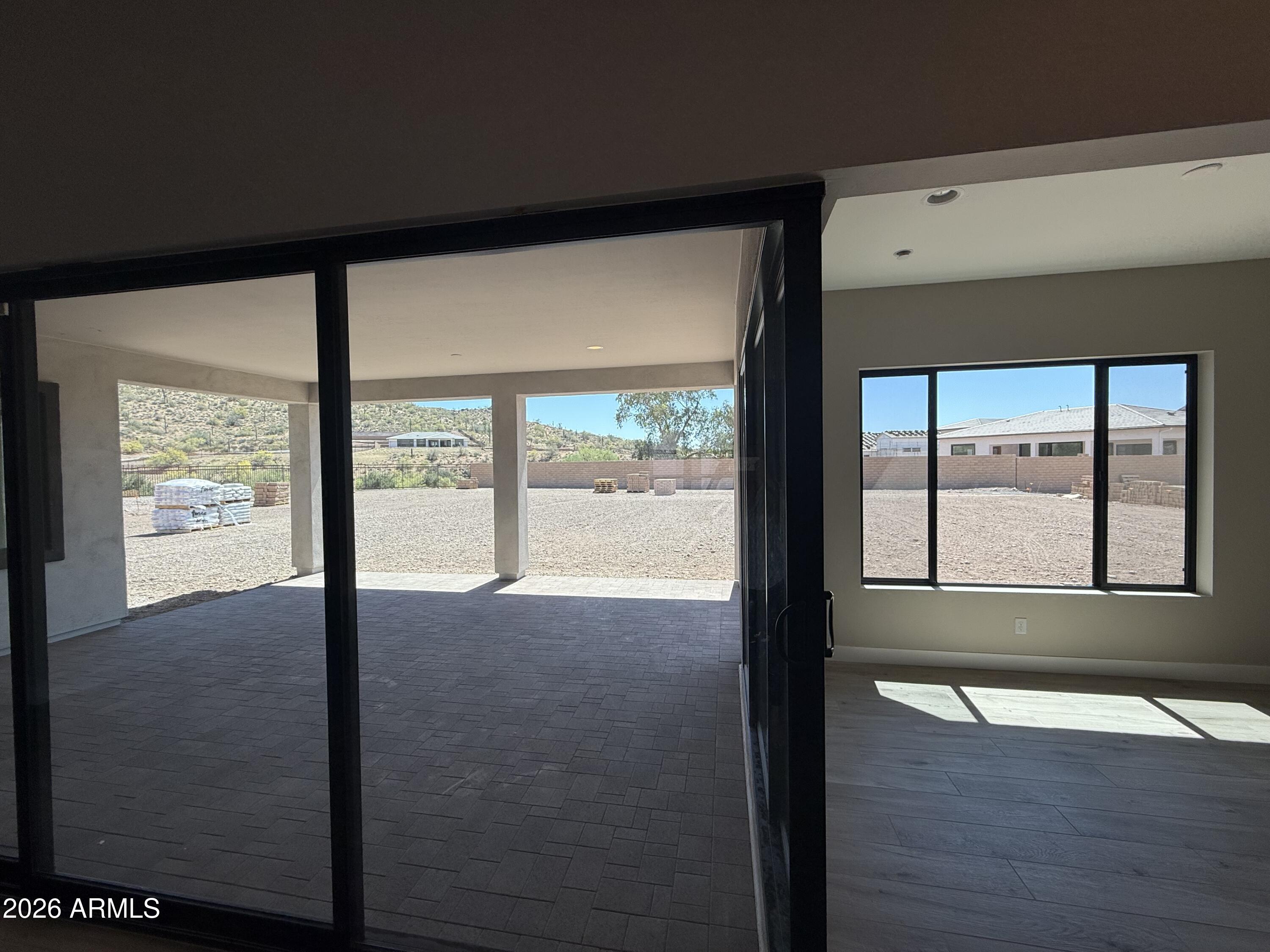 11139 East Rio Bravo Road Gold Canyon, AZ 85118 - Photo 5 of 14 a view of an empty room with wooden floor and a window