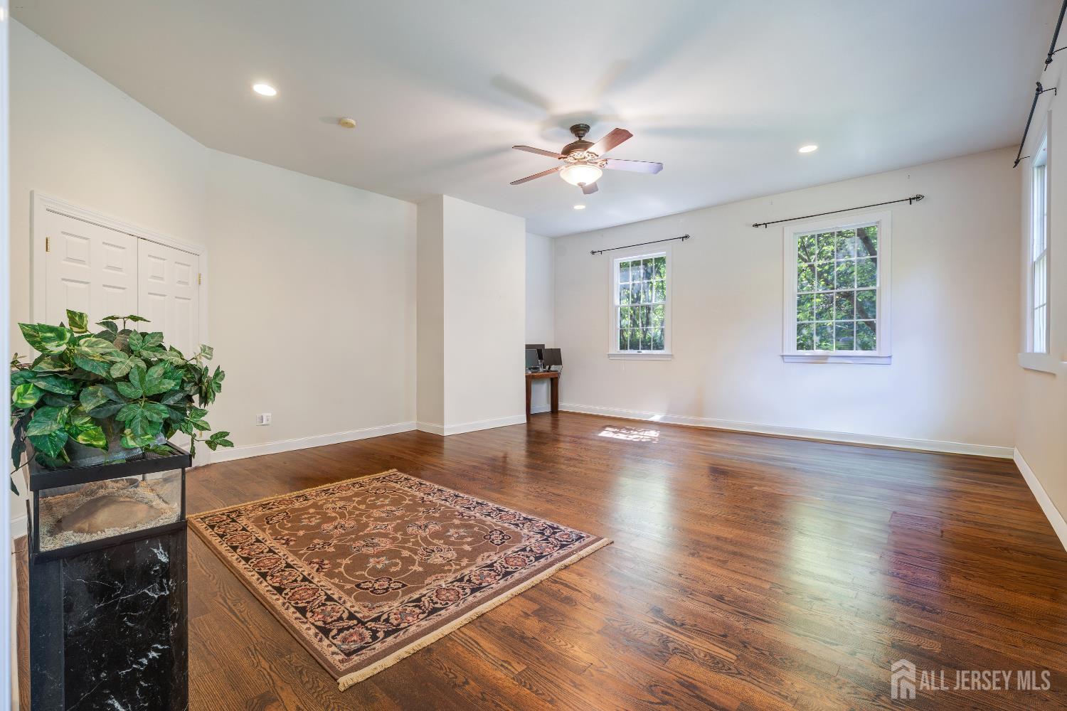 32 4 Bridges Road Chester, NJ 07930 - Photo 27 of 78 a view of an empty room with a potted plant and wooden floor