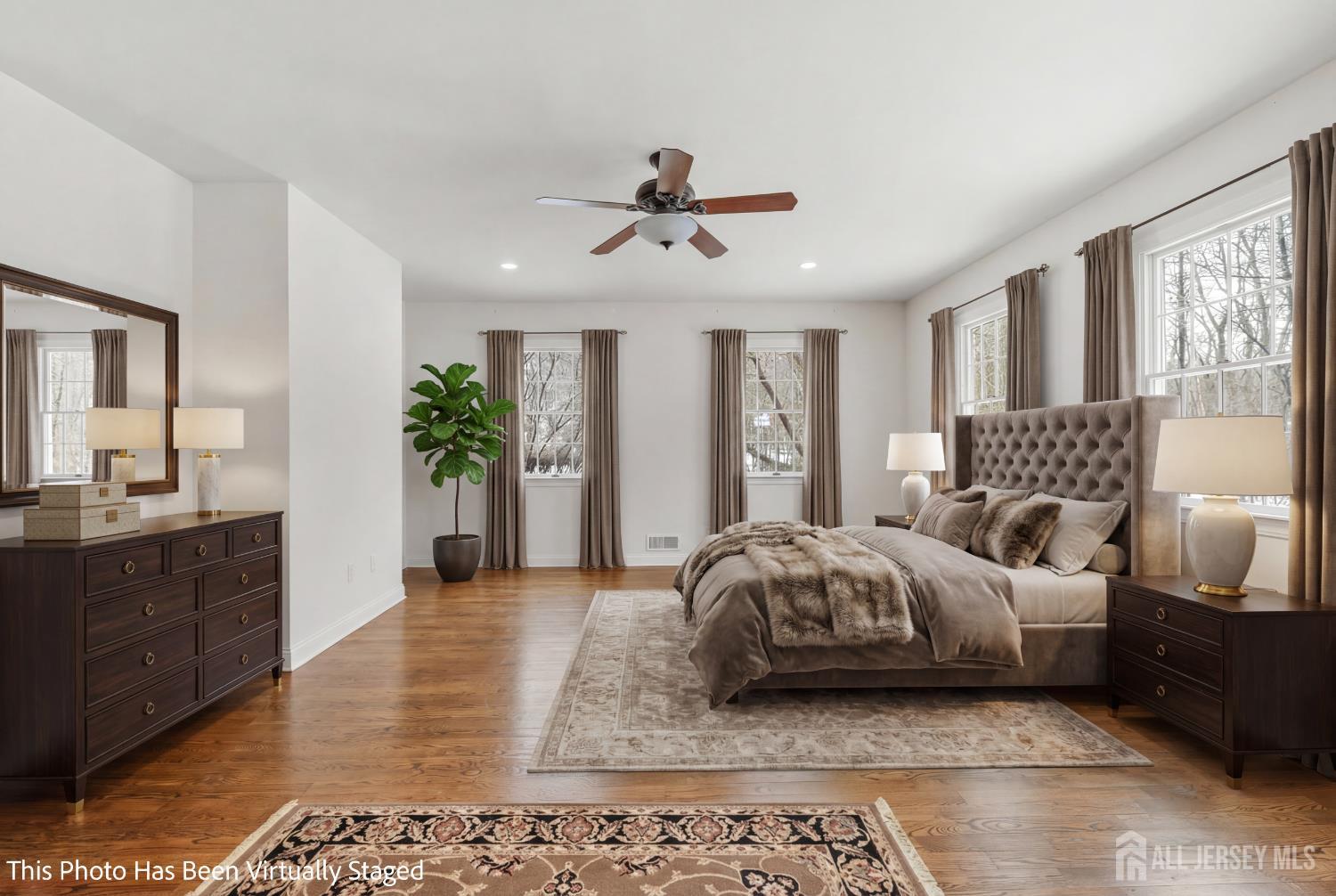 32 4 Bridges Road Chester, NJ 07930 - Photo 28 of 78 a spacious bedroom with a bed a couch and large windows