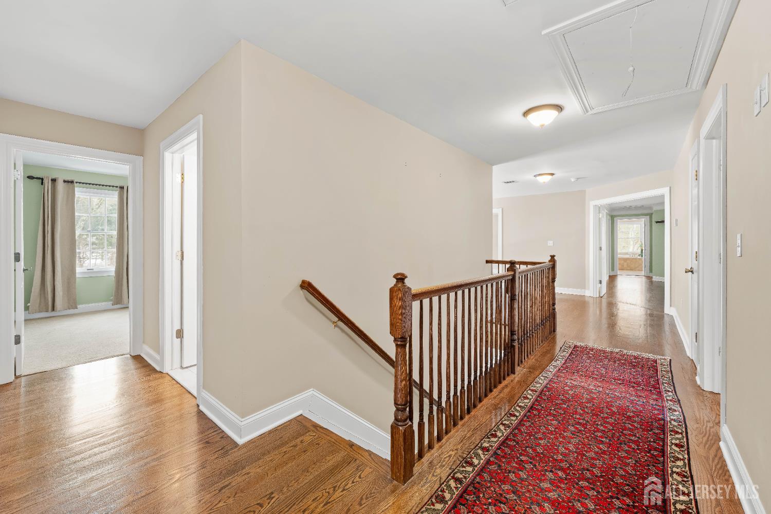 32 4 Bridges Road Chester, NJ 07930 - Photo 36 of 78 a view of a hallway with wooden floor and windows