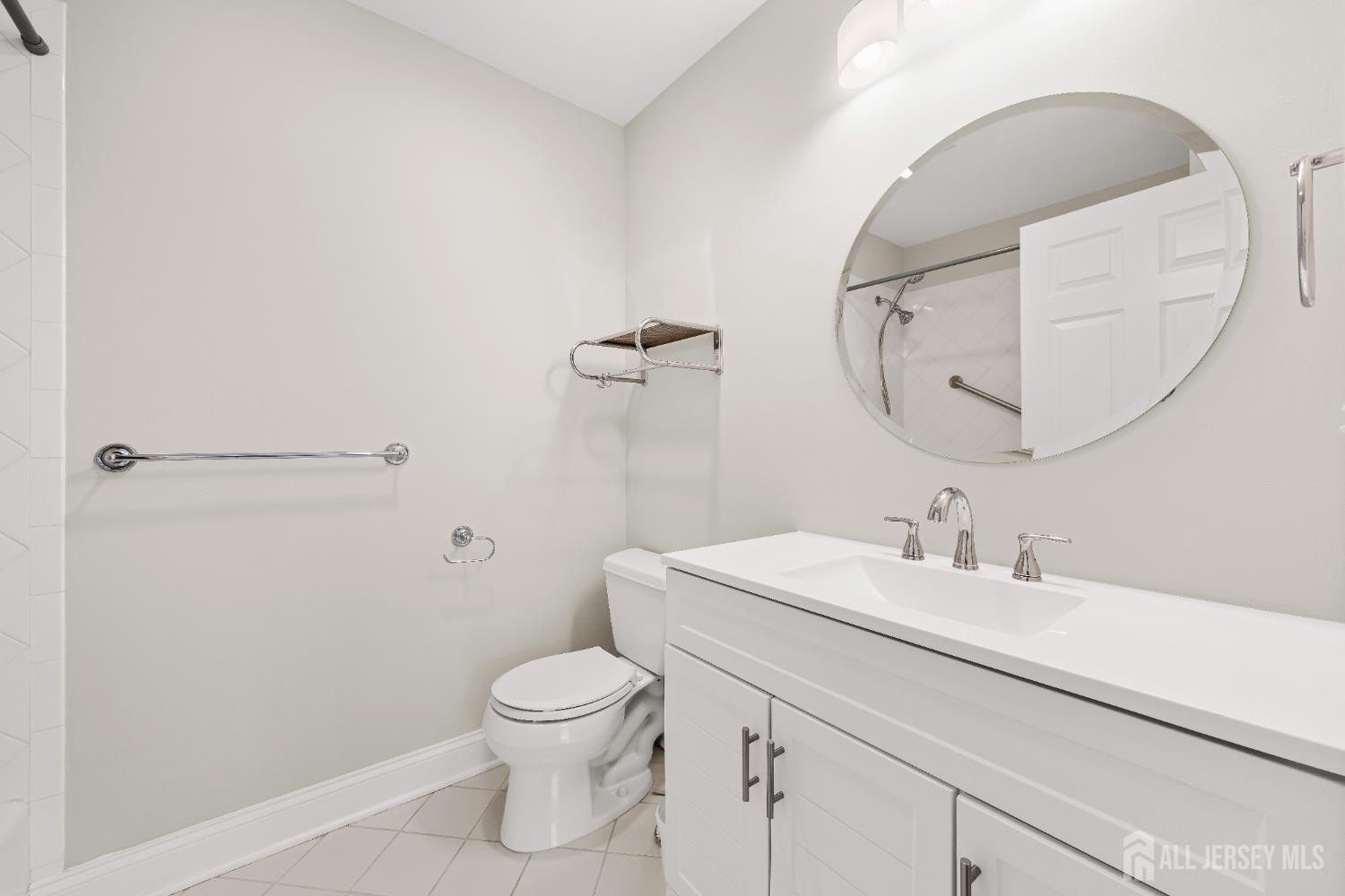 32 4 Bridges Road Chester, NJ 07930 - Photo 56 of 78 a bathroom with a sink a toilet and a mirror