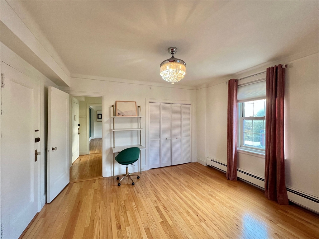 1454 Beacon Street, Unit 744 Brookline, MA 02446 - Photo 11 of 18 a view of a livingroom with wooden floor and a large window