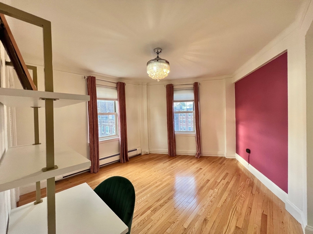 1454 Beacon Street, Unit 744 Brookline, MA 02446 - Photo 12 of 18 a view of an empty room with window and wooden floor