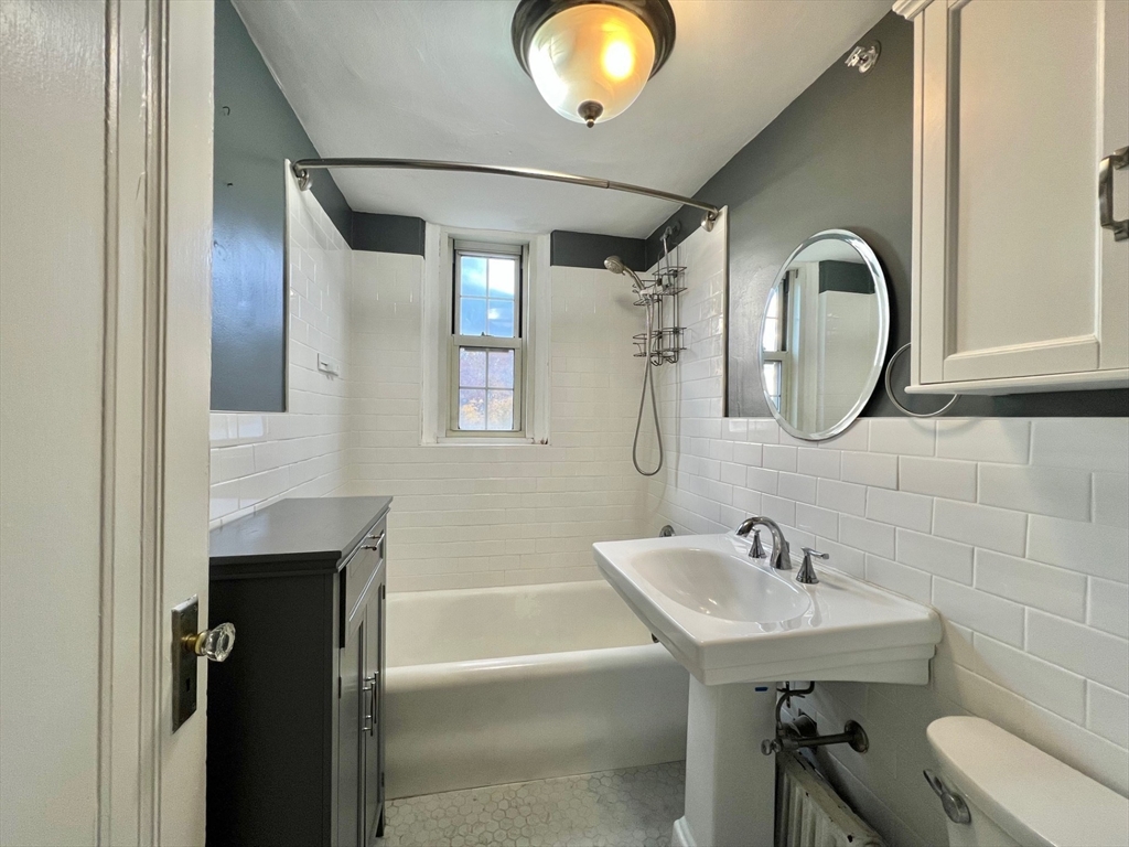 1454 Beacon Street, Unit 744 Brookline, MA 02446 - Photo 13 of 18 a bathroom with a sink and a mirror