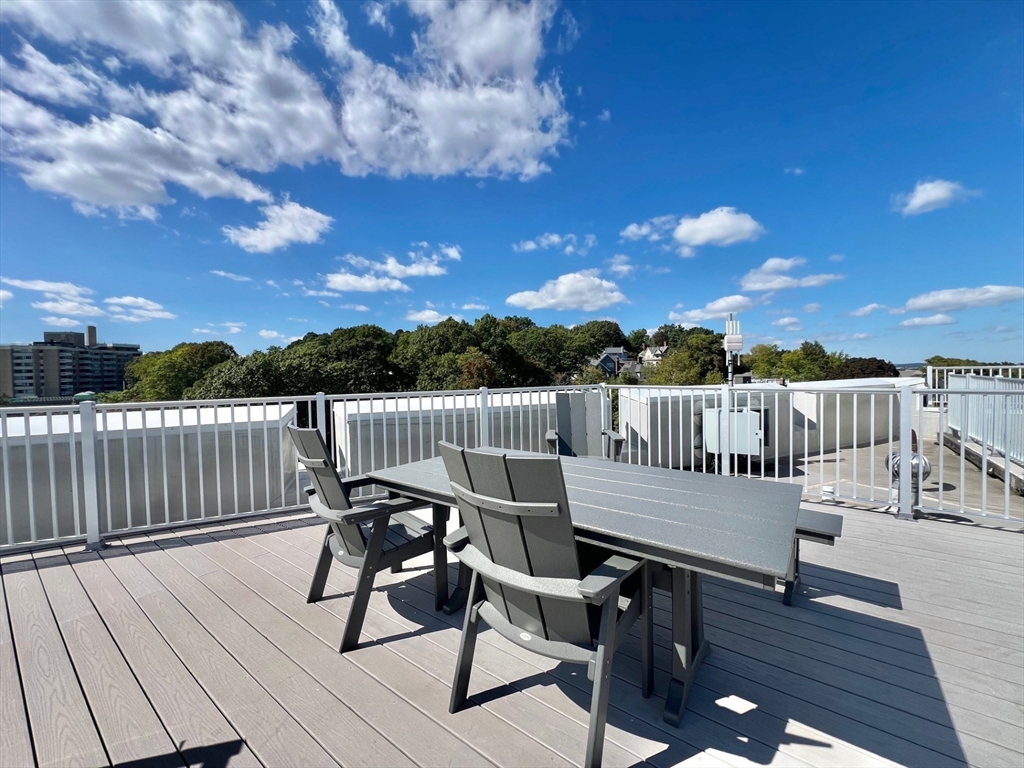 1454 Beacon Street, Unit 744 Brookline, MA 02446 - Photo 14 of 18 a view of a roof deck with chair and wooden floor