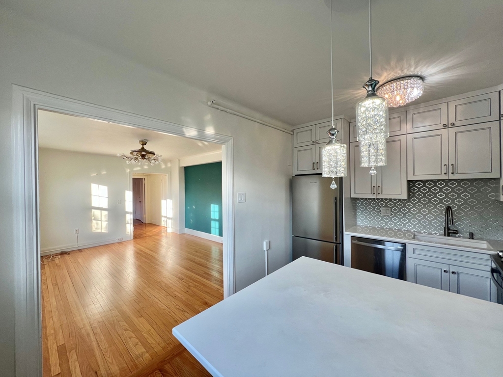 1454 Beacon Street, Unit 744 Brookline, MA 02446 - Photo 2 of 18 a kitchen with stainless steel appliances a refrigerator sink and cabinets