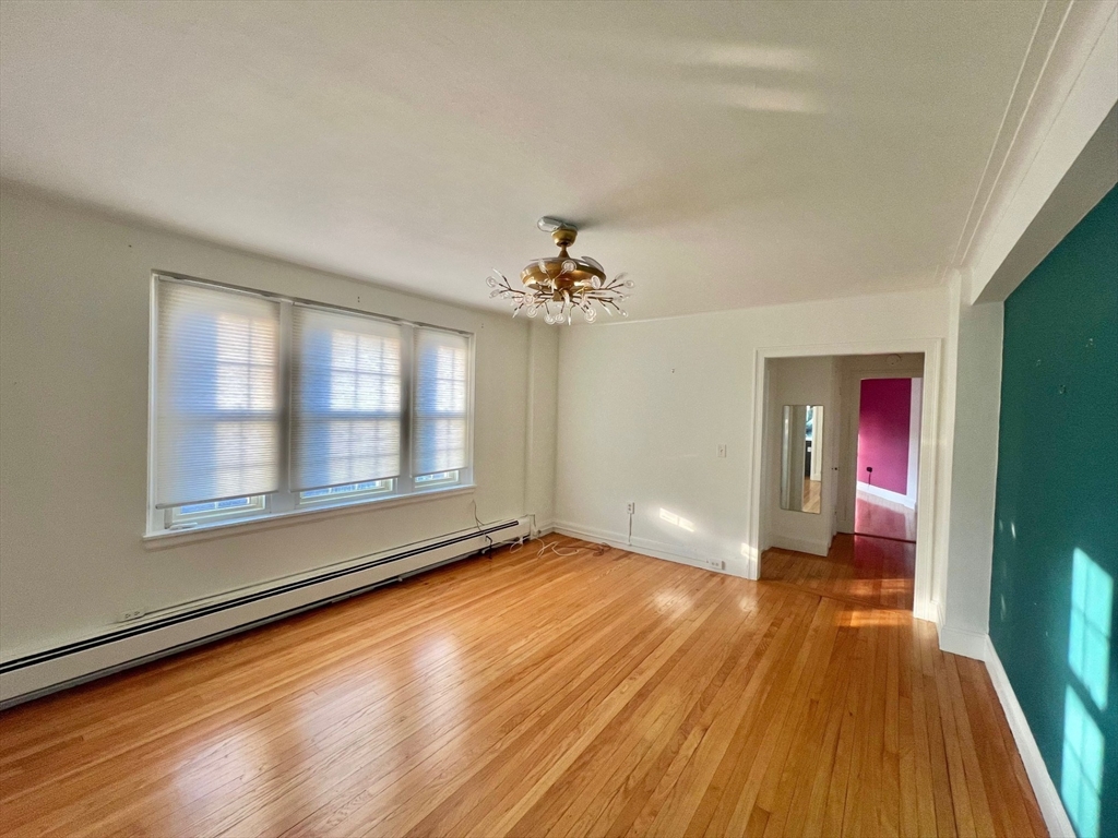 1454 Beacon Street, Unit 744 Brookline, MA 02446 - Photo 7 of 18 wooden floor in an empty room with a window