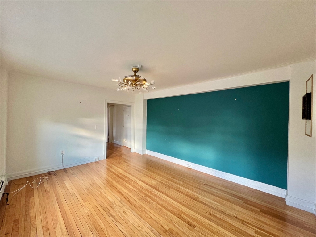 1454 Beacon Street, Unit 744 Brookline, MA 02446 - Photo 8 of 18 a view of room with window and wooden floor