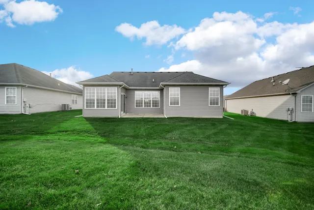 a view of a house with a big yard and large trees