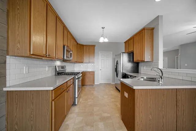 a kitchen with a sink stove and cabinets