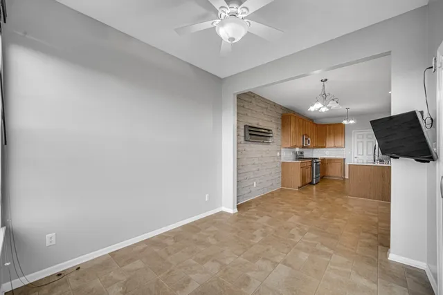 a view of a kitchen with a sink and a ceiling fan