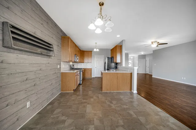 a large kitchen with kitchen island a stove a sink dishwasher and a refrigerator