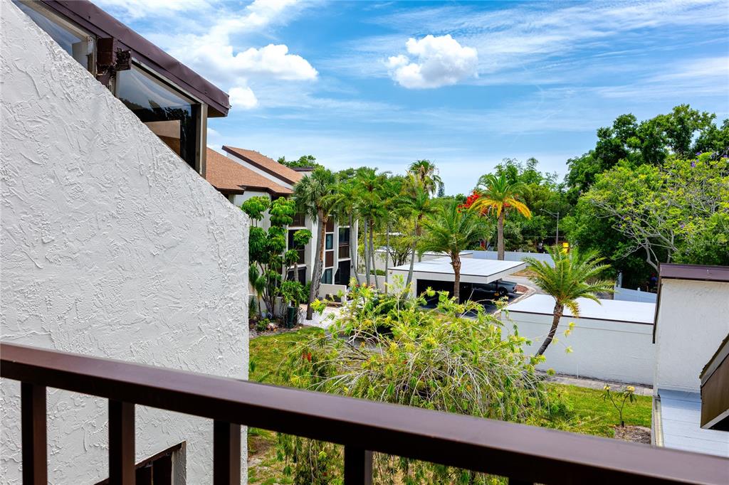 2207 Belleair Road, Unit B30 Clearwater, FL 33764 - Photo 29 of 39 a balcony with chairs and a flower pot
