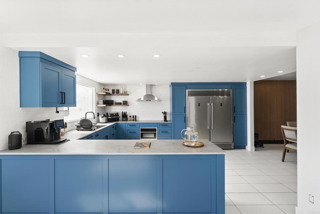 9309 Hillside Drive Spring Valley, CA 91977 - Photo 16 of 64 a kitchen with kitchen island granite countertop a sink and cabinets