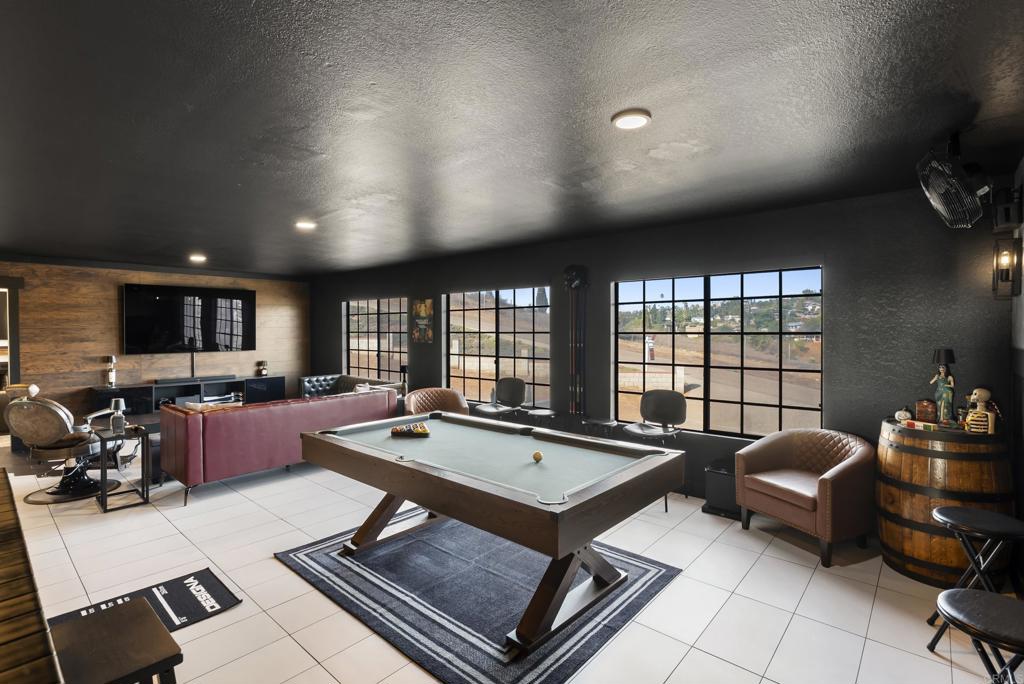 9309 Hillside Drive Spring Valley, CA 91977 - Photo 27 of 64 a living room with furniture a flat screen tv and a large window