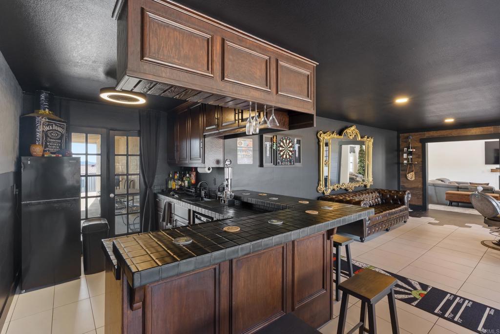 9309 Hillside Drive Spring Valley, CA 91977 - Photo 28 of 64 a kitchen with stainless steel appliances granite countertop a sink stove and refrigerator