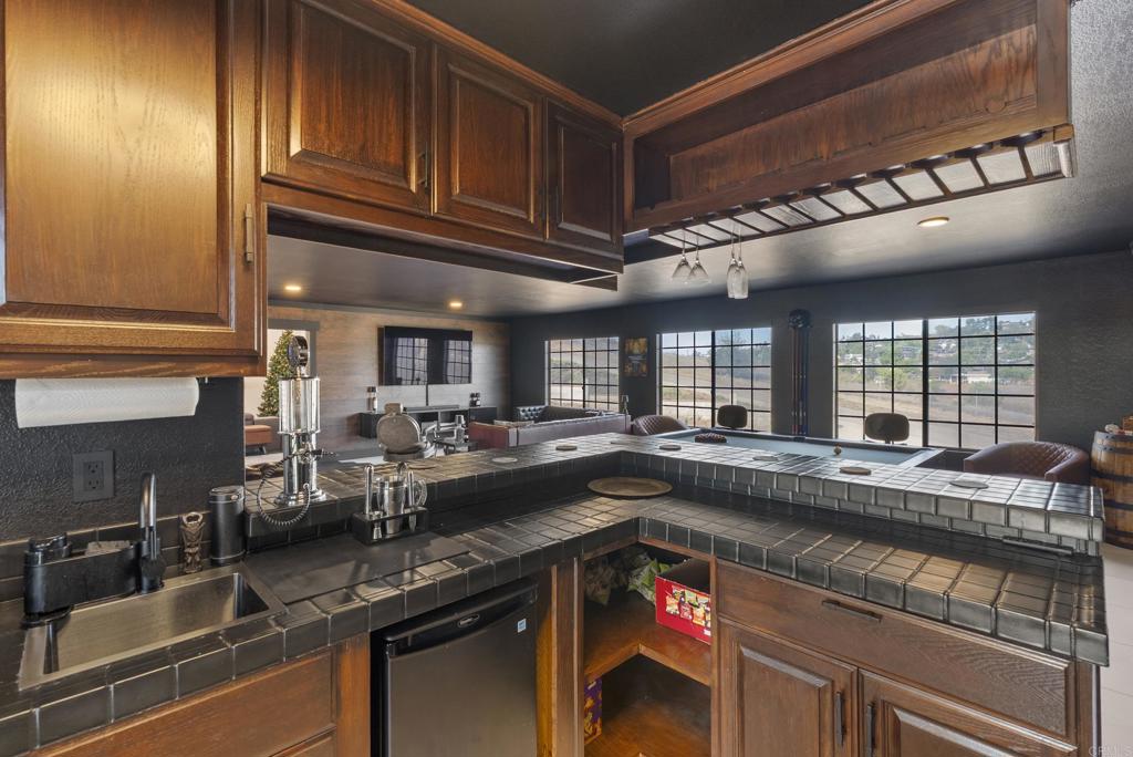 9309 Hillside Drive Spring Valley, CA 91977 - Photo 30 of 64 a kitchen with granite countertop a sink a stove and cabinets