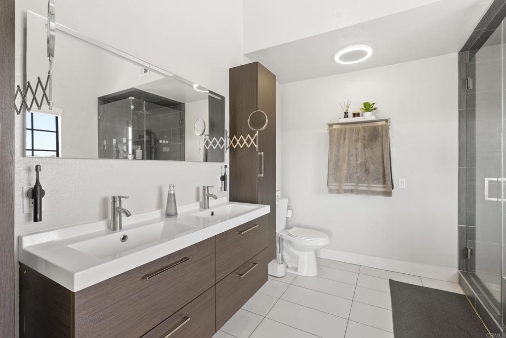 9309 Hillside Drive Spring Valley, CA 91977 - Photo 37 of 64 a bathroom with a toilet sink and mirror