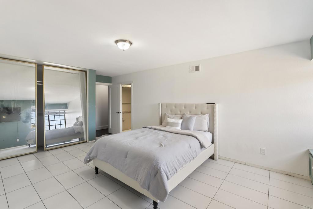 9309 Hillside Drive Spring Valley, CA 91977 - Photo 42 of 64 a spacious bedroom with a bed and glass door