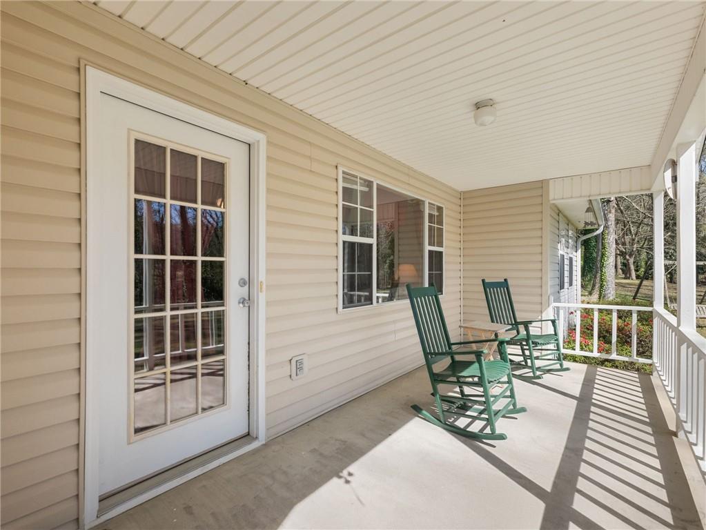 2741 Old Dawsonville Road Gainesville, GA 30506 - Photo 3 of 18 a balcony with table and chairs and potted plants