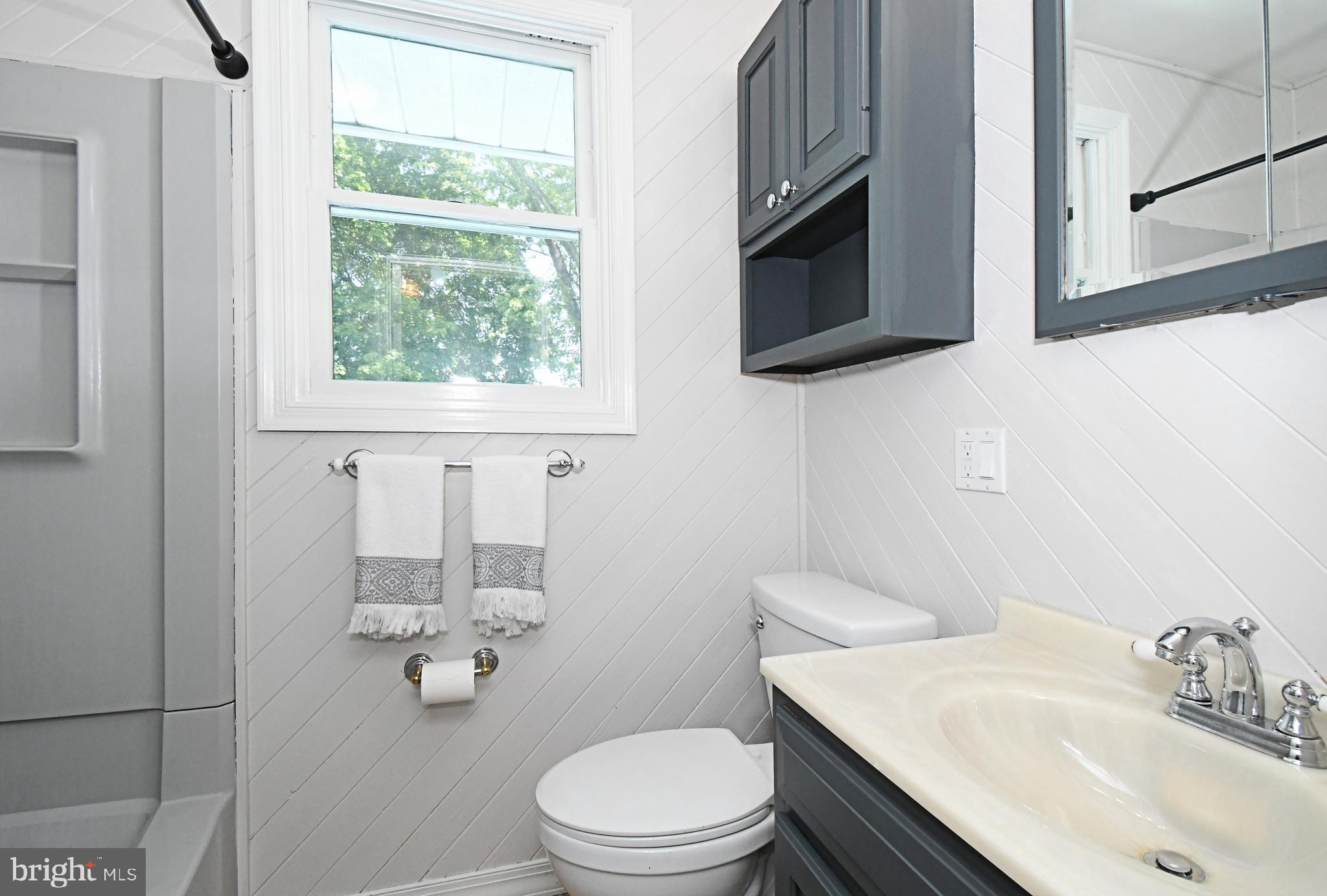 609 Mansfield Road Willow Grove, PA 19090 - Photo 29 of 68 a bathroom with a toilet a sink and mirror