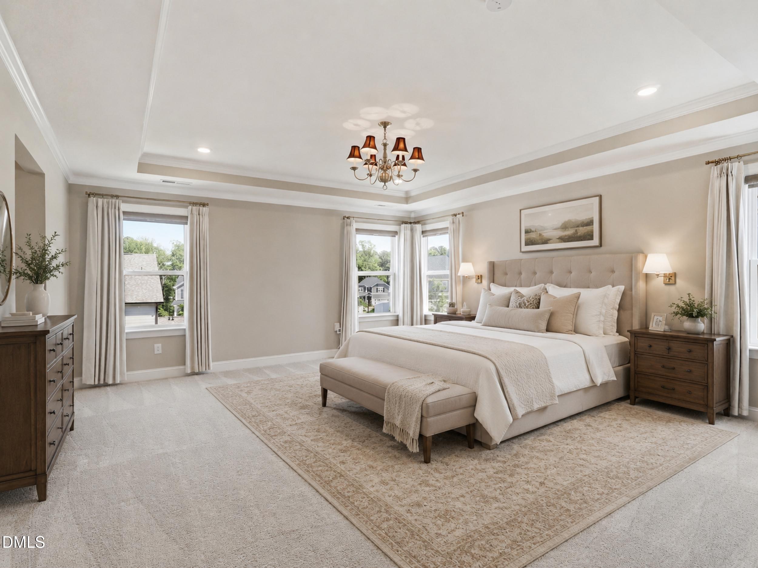 2709 Womble Ridge Drive New Hill, NC 27562 - Photo 29 of 60 a spacious bedroom with a large bed and a chandelier