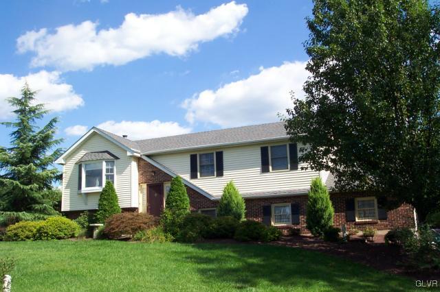 2131 Hendricks Road Pennsburg, PA 18073 - Photo 3 of 30 a front view of a house with a garden and trees