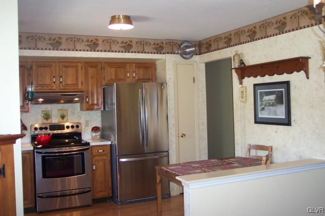 2131 Hendricks Road Pennsburg, PA 18073 - Photo 8 of 30 a kitchen with stainless steel appliances a refrigerator and a stove top oven