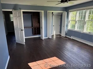 an empty room with wooden floor and a window