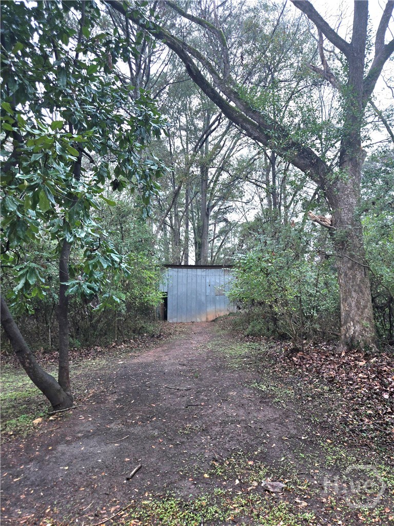 2569 Riverbend Road Athens, GA 30605 - Photo 36 of 44 View of the back of the property with the outbuilding with electricity. Ideal for artists, carpenters, potters, musicians, gardeners and more.