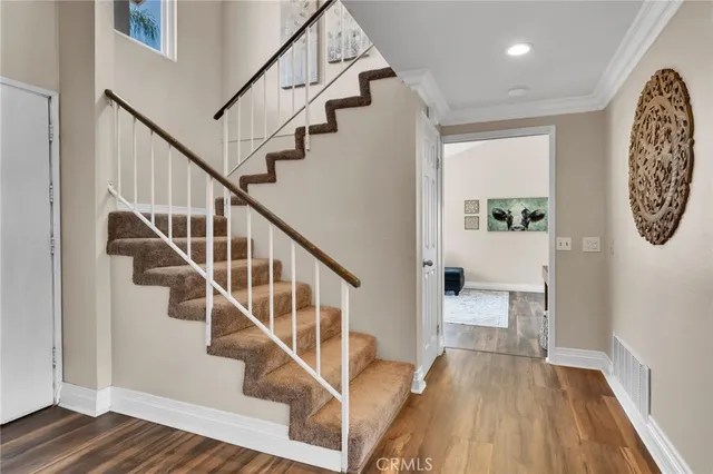 a view of entryway and hall with wooden floor