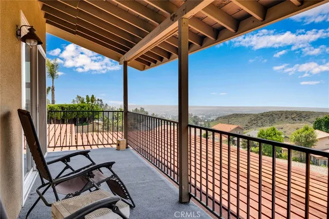 a view of a chairs and table in the balcony
