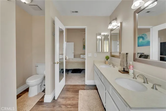 a spacious bathroom with a double vanity sink toilet and shower