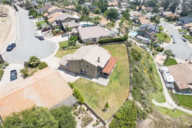 an aerial view of a house with a yard and lake view