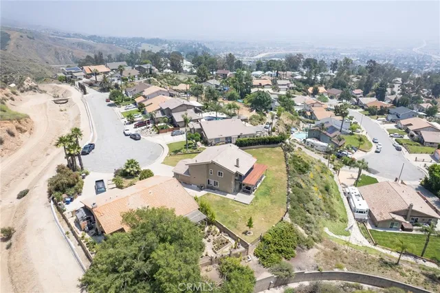 an aerial view of residential houses with outdoor space