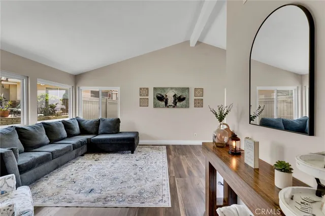 a living room with furniture and a mirror
