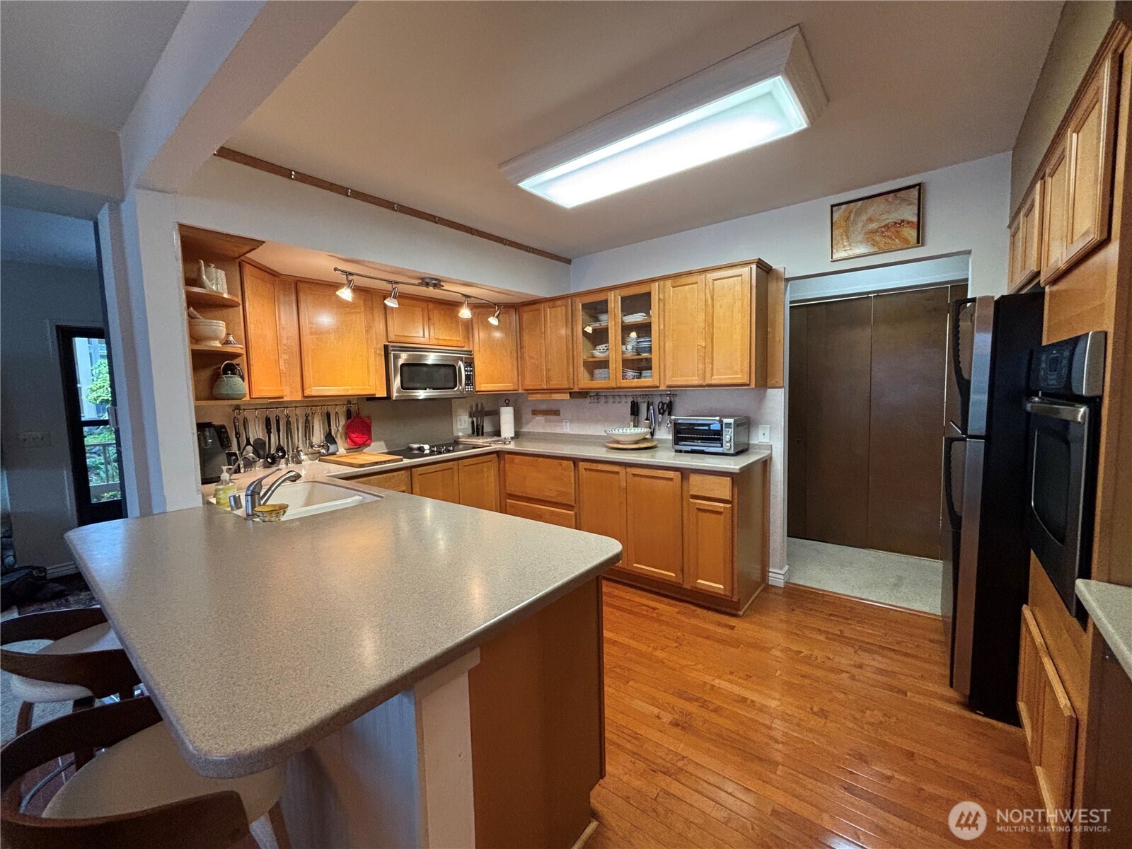 221 North Bay Lane, Unit 2 Port Ludlow, WA 98365 - Photo 12 of 35 a large kitchen with kitchen island a large counter top appliances and cabinets