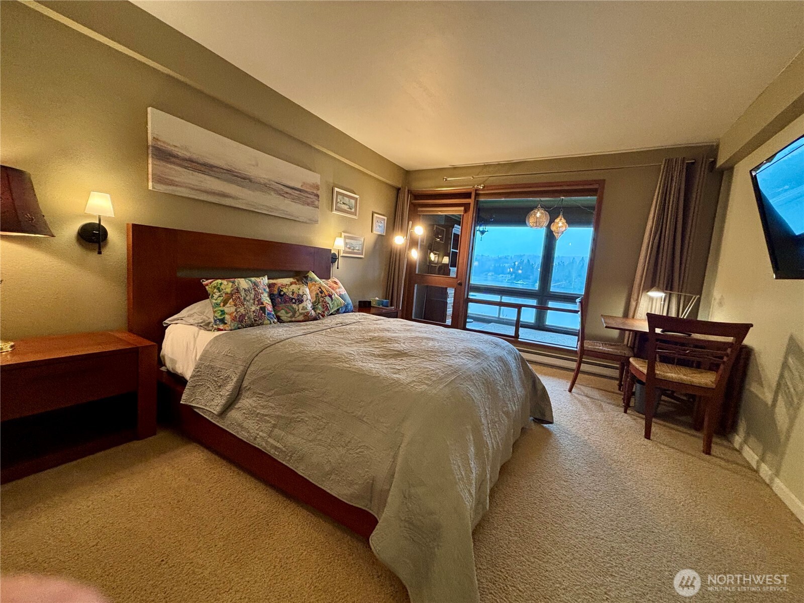 221 North Bay Lane, Unit 2 Port Ludlow, WA 98365 - Photo 23 of 35 a bedroom with a bed a chair and potted plant on the dresser