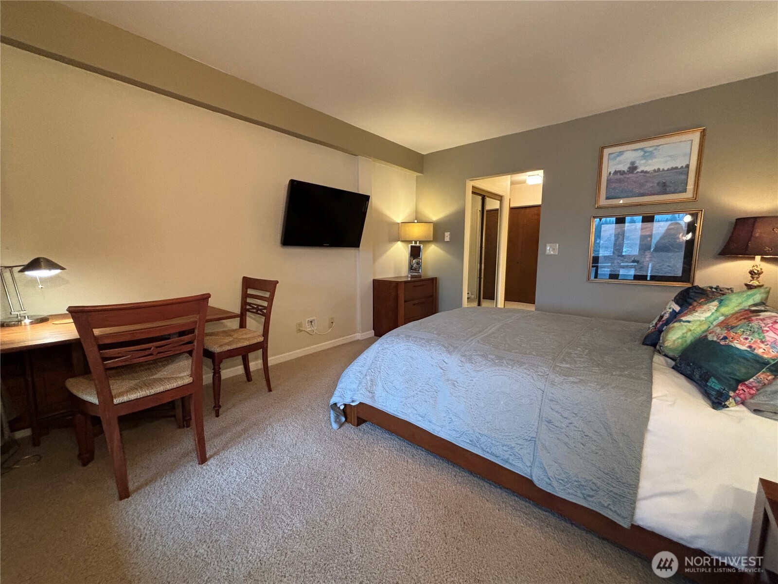 221 North Bay Lane, Unit 2 Port Ludlow, WA 98365 - Photo 24 of 35 a bedroom with a bed and a flat screen tv