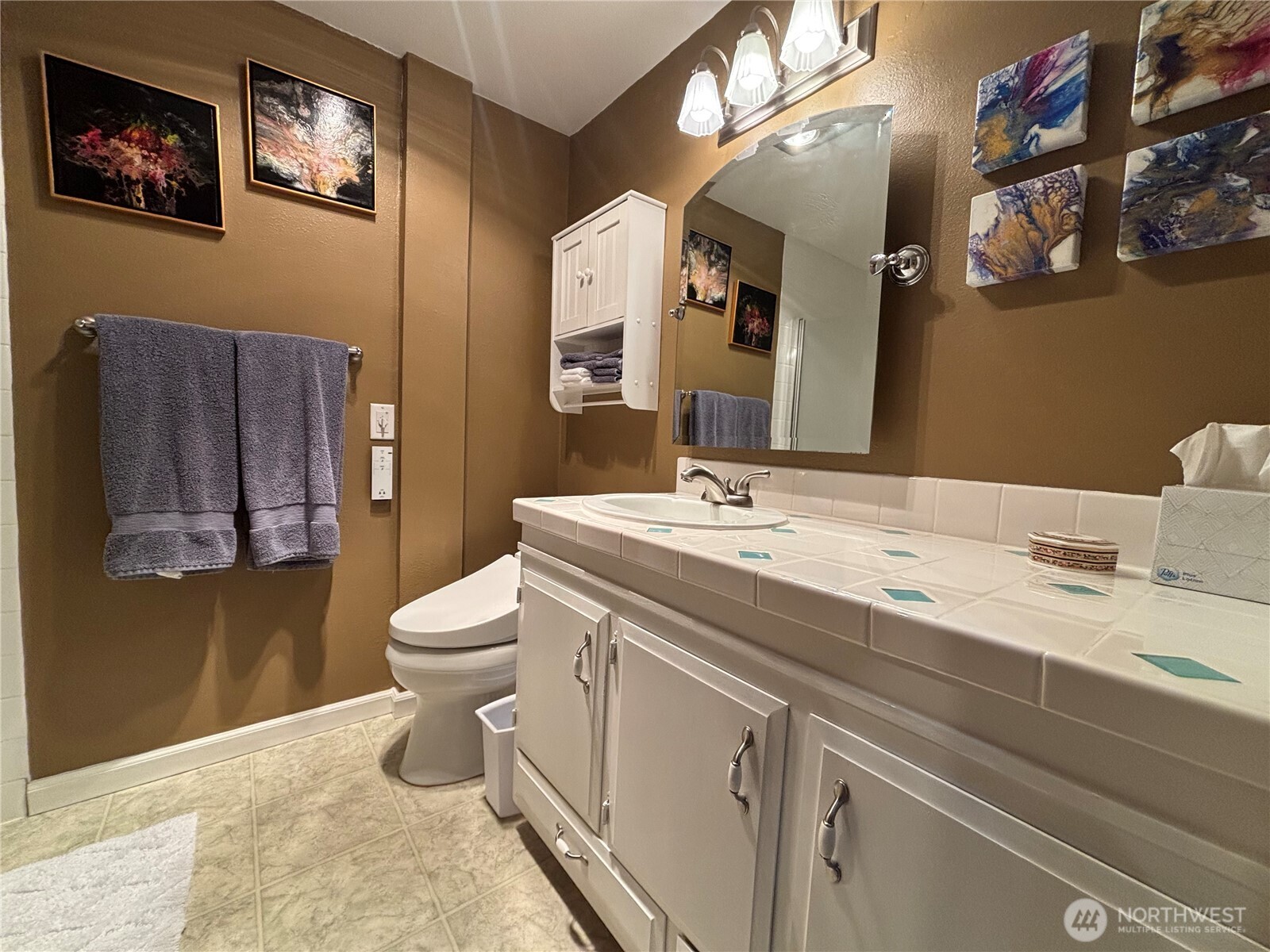 221 North Bay Lane, Unit 2 Port Ludlow, WA 98365 - Photo 26 of 35 a bathroom with a toilet a sink and mirror